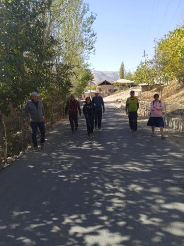 a group of people walking down a road at Spring Family Guest House in Tersak