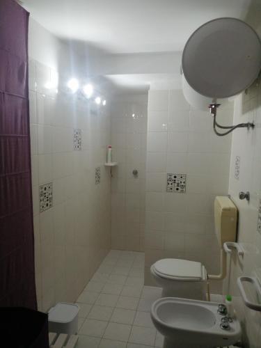 a bathroom with a shower and a toilet and a sink at Scrusciu do Mari in Butera