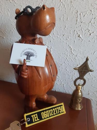 a statue of a teddy bear in a pot with a sign at KITOKO L'HERAULT gite close to SALAGOU Lake in Clermont-lʼHérault