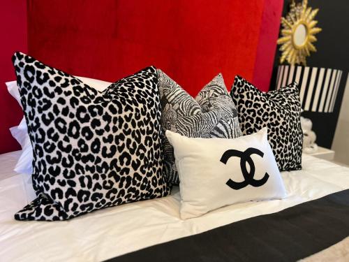 a bed with black and white pillows on it at Smithgrove Guesthouse in Pietermaritzburg