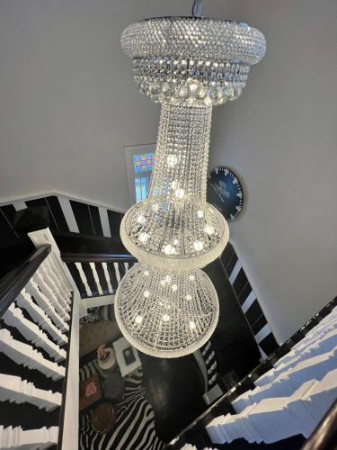 a large chandelier is hanging from a staircase at Smithgrove Guesthouse in Pietermaritzburg