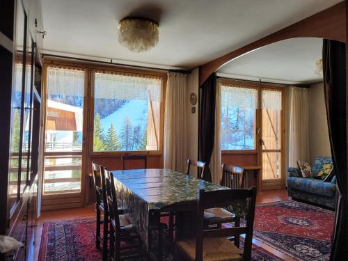 a dining room with a table and chairs at Over The Snow Apartment in Borgata Sestriere