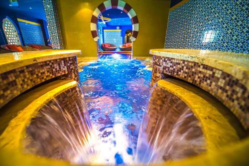 a water feature in a hotel with a waterfall at Shiraz Hotel Superior in Egerszalók
