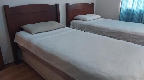 two beds sitting next to each other in a bedroom at Jay's Guest House in Witbank