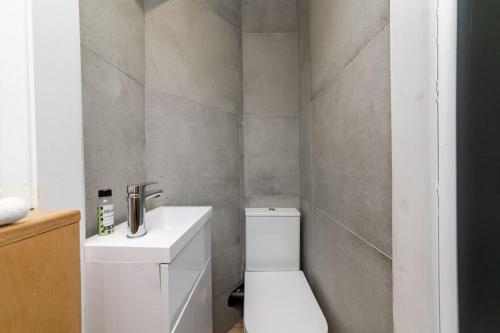 a bathroom with a white toilet and a sink at The Keep at Castlegate - Luxury detached retreat in Cragg vale, Hebden Bridge in Mytholmroyd