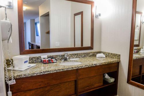 a bathroom with a sink and a mirror at Travelodge by Wyndham Culver City in Los Angeles