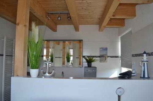 a bathroom with a sink and a mirror at HM - Ferienhaus 2 Deluxe Krombachtalsperre Westerwald exklusive verbrauchte NK in Driedorf