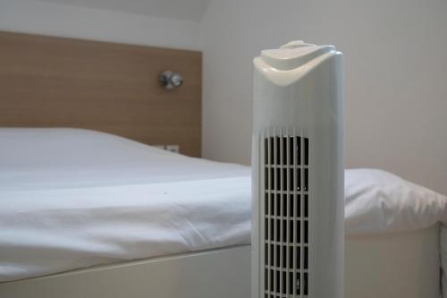 a room with a bed with a radiator next to it at La petite maison 3 in Avoine