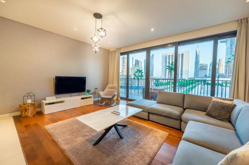 a living room with a couch and a tv at FAM Living - City Walk - Urban Staycations 6A&B in Dubai