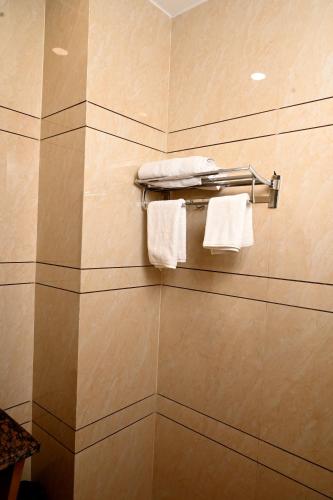 a bathroom with white towels on a towel rack at Hotel Diamond Villa l Hotel Near Golden Temple Amritsar l Hotel In Amritsar l Best Hotel In Amritsar in Amritsar