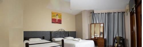 En eller flere senge i et værelse på Hostal Ibiza