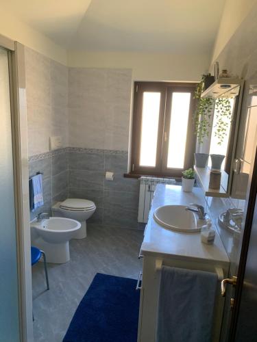 a bathroom with a toilet and a sink and a toilet istg at Rita’s Loft in Castelpetroso