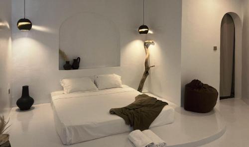 a white room with a bed and a lamp at Bassa nova villa in Panglao