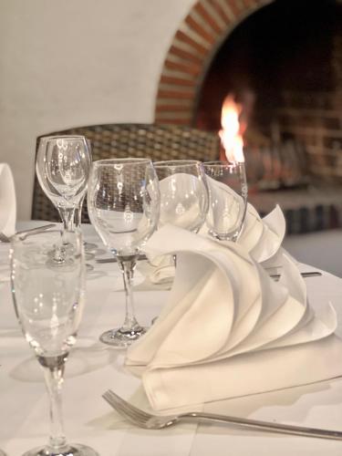 a table with wine glasses and a napkin on it at relexa hotel Schatten Stuttgart in Stuttgart
