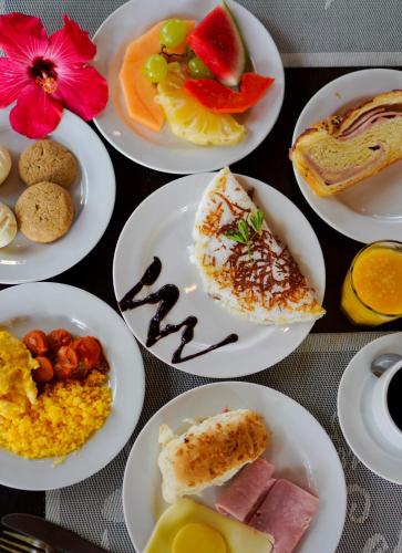 a bunch of plates of food on a table at ThalassaGarden Hotel - Pousada in Pipa