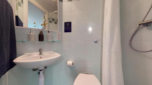 een witte badkamer met een wastafel en een toilet bij Comfy Ensuite Bedrooms at Manchester Gardens near City Centre in Manchester