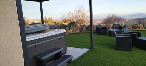 an outdoor kitchen with a view of a garden at La Halte Gourmande in Vachères