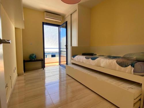 a bedroom with a bed and a view of the ocean at Villa Maria Luisa in Playa Blanca