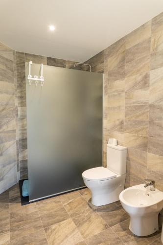 a bathroom with a toilet and a sink at Casa do Outeiro in Arcos de Valdevez