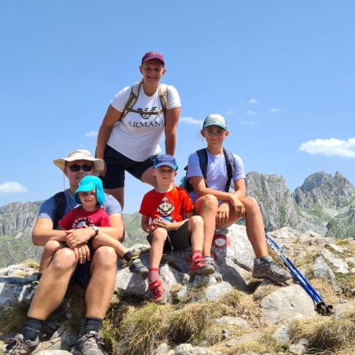 a group of people sitting on top of a mountain at PROKLETIJE eko katun Vusanje in Gusinje