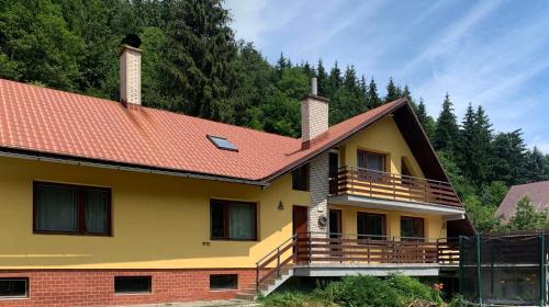 a yellow house with a red roof at Bystravilla in Bystrá