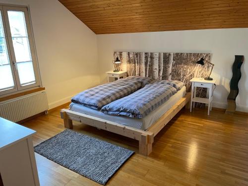 A bed or beds in a room at Interlaken Apartments