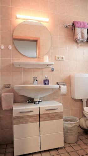 a bathroom with a sink and a toilet at Pension BRUNI in Oberbach