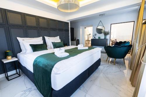 a large bedroom with a large bed and a chair at Penzion Monner in Mikulov
