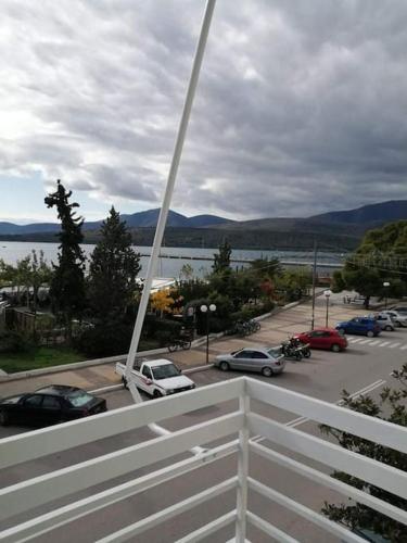 a view of a parking lot with a white fence at Lovely sea front apartment in Itea