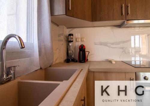 a kitchen with a sink and a counter top at Leo's Stone made Villa! in Karavádhos