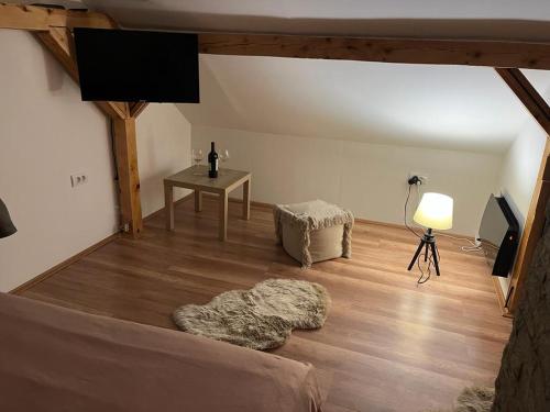 a living room with a bed and a table at Vila Xenos Loft Karakter Zlatibor in Zlatibor