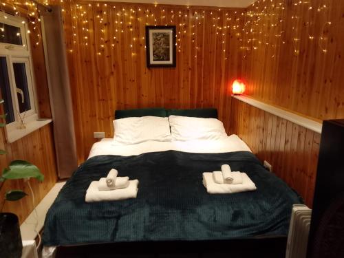 a bedroom with a bed with two towels on it at Pilgrims of the Goddess in Glastonbury