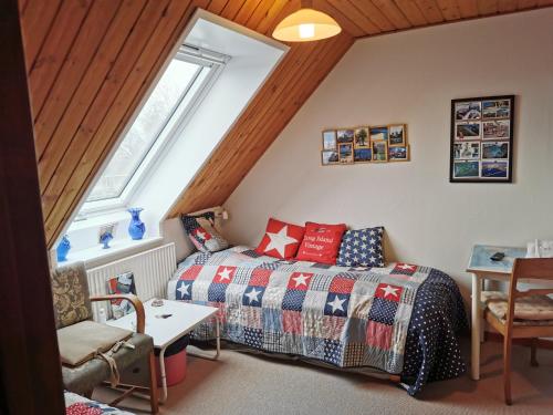 a bedroom with a bed and a table and a window at Annys Bed & Breakfast in Sunds