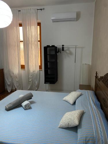 um quarto com uma cama com duas almofadas em Casa Il Tulipano em Gioiosa Marea