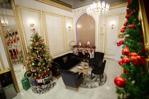 a living room with christmas trees and christmas decorations at Renaissance Boutique Hotel in Samarkand