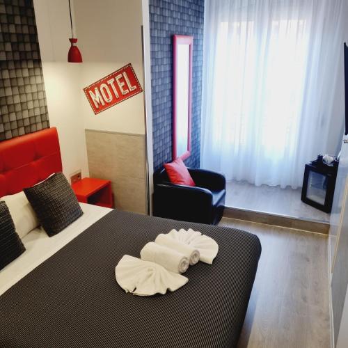 a hotel room with a bed with towels on it at Hostal Lauria in Madrid