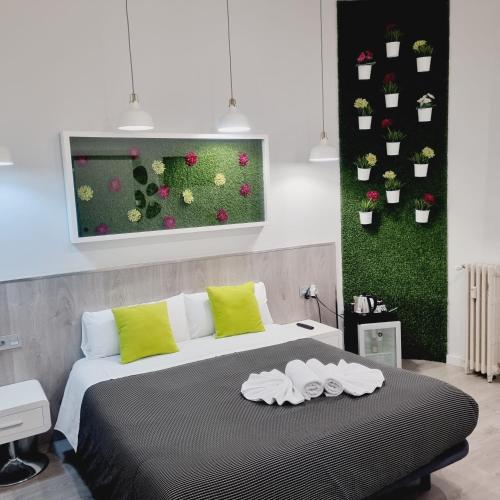 a bedroom with a bed with two towels on it at Hostal Lauria in Madrid