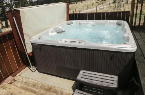 a jacuzzi tub on a deck with at Rocky Mountain Retreat 2 by Rocky Mountain Resorts in Estes Park