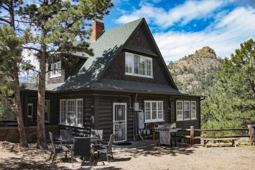 a house in the mountains with a table and chairs at Aspen Mountain Lodge - #3357 in Estes Park