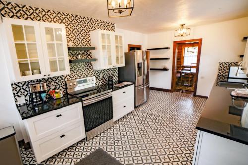 a kitchen with white cabinets and a refrigerator at Aspen Mountain Lodge - #3357 in Estes Park