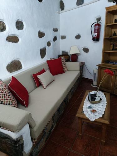 a living room with a couch and a table at La Casona Del Almendro in San Bartolomé de Tirajana