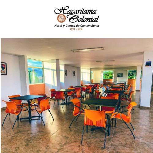 a cafeteria with tables and chairs in a building at Hotel Hacaritama Colonial in Villavicencio