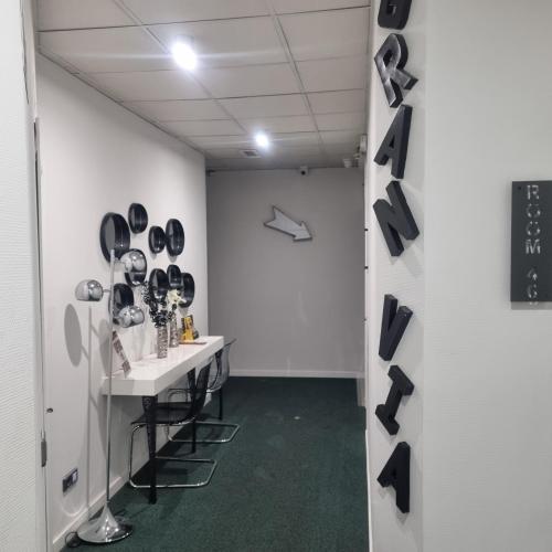 a dressing room with black shoes hanging on the wall at Hostal Lauria in Madrid