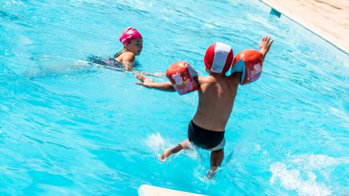 two people in a swimming pool wearing pads at Hotel Vega Perugia in Perugia