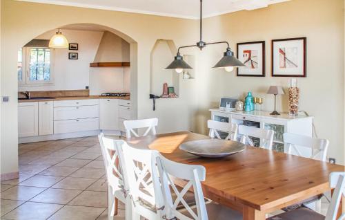 a kitchen and dining room with a wooden table and chairs at Nice Home In Caunes Minervois With Wifi in Caunes-Minervois