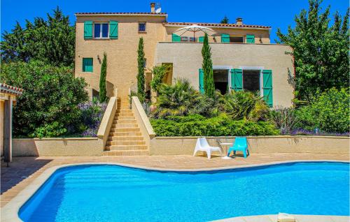 a house with a swimming pool in front of a house at Nice Home In Caunes Minervois With Wifi in Caunes-Minervois