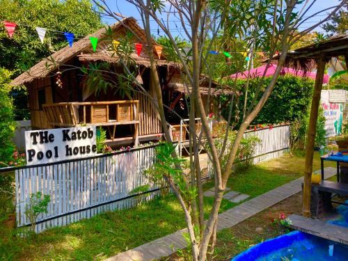 a house with a sign that reads the kota pool house at เดอะกระต็อบพลูเฮ้าส์ By The Mountain Ozoneบ้านโอโซนขุนเขาแก่งกระจาน in Ban Song Phi Nong