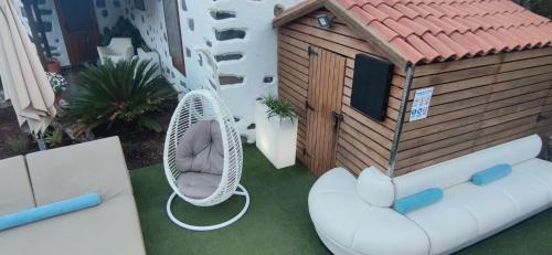 a model of a house with a couch and a chair at La Casona Del Almendro in San Bartolomé de Tirajana