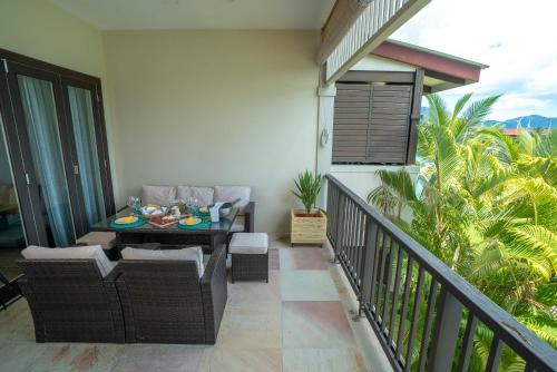a patio with a table and chairs on a balcony at P146A13 - Eden Island Self Catering Apartment Self Check In in Eden Island