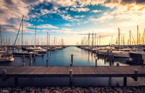 a dock with boats docked in a marina at Ferienwohnung in Ostseenähe in Kröpelin